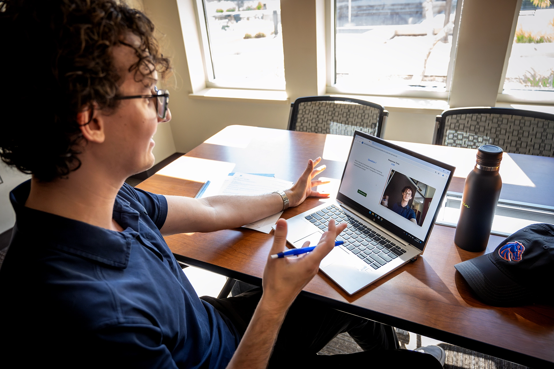 Student responding to Rhetorix Lab question on laptop